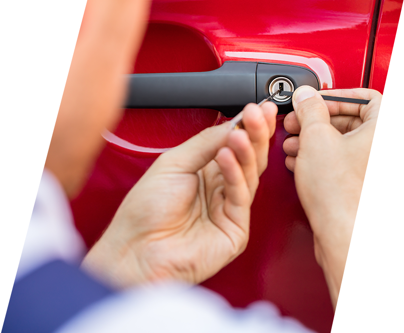 Professional locksmith unlocking car door with specialized tools in Dubai