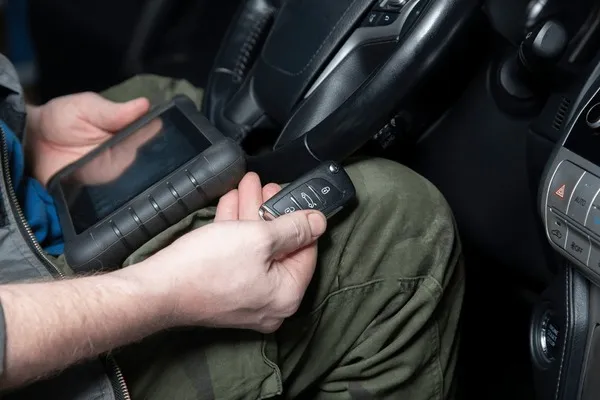 Technician programming BMW car keys in Dubai Marina